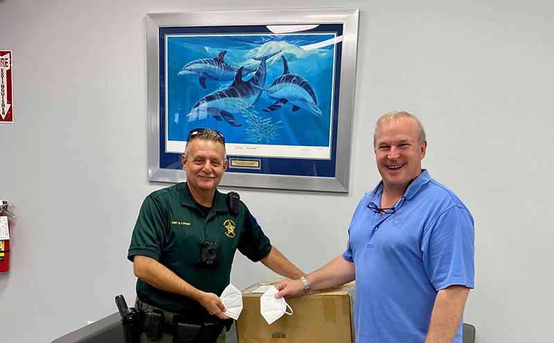 (L-R): Broward Deputy Sheriff Scott Longo accepts a donation of face masks from Pompano Beach-based Life Wear Technologies CEO Bradley Waugh. Life Wear Technologies donated 3,000 face masks to the Broward Sheriff’s Office and Pompano Beach Fire Rescue.