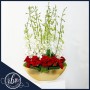 Love on a Golden Boat: Elegant Flower Arrangement with Red Roses and White Orchids